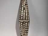 sculpture of a corn on a white background with a shadow on the wall