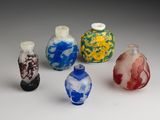 several small glass vases are lined up on a white surface