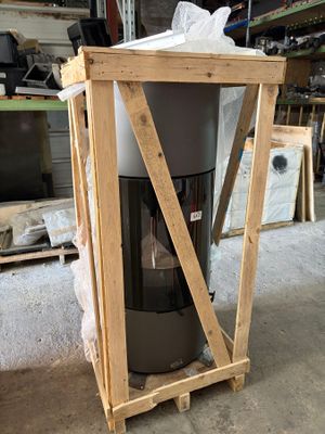 a trash can sitting on top of a wooden stand