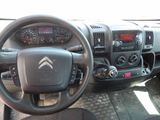 the interior of a car with a steering wheel, dashboard, and dashboard controls