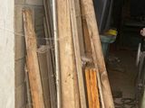 a pile of wood leaning against a wall in a garage