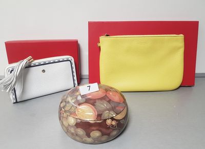 two purses and a coin jar on the table
