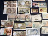 many different types of paper money on a table