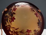 a brown plate with a floral design on it on a table