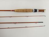 four different types of fishing rods are lined up on a white surface