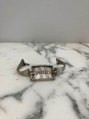 bracelet manchette plaqué argent sur lequel est gravé le mot « faith »