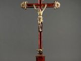 a red and gold crucif with a cross on top of it