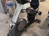 a stationary exercise bike in a garage with a water bottle