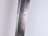 a close up of a knife on a white surface