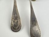 two spoons and a fork sitting on a table
