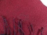 red wool scarf with black fringes on a white background