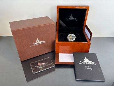 a box with a watch inside of it on a table