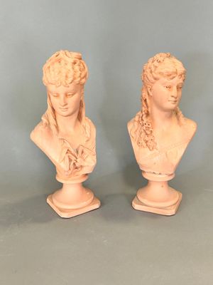 pair of white marble busts of a woman and a man