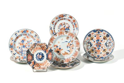 five plates and two cups and saucers on the table