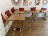 tables and chairs are lined up in a corner in a restaurant