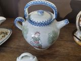 a table with a tea pot, tea pot, and other items on it