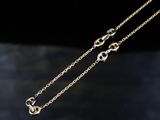 a pair of gold chain necklaces on a black surface