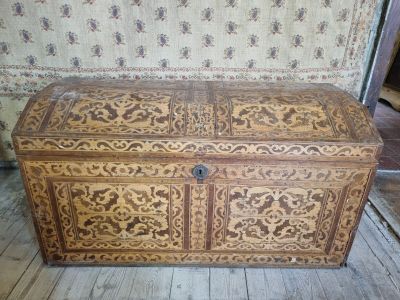 a large wooden chest with intricate carvings on it