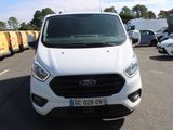 a white ford transit van parked in a parking lot