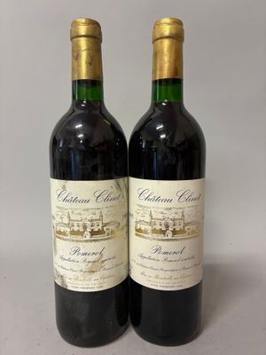 two bottles of red wine sitting next to each other on a table