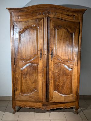 a wooden armoire with two doors on it