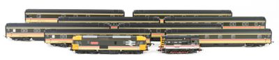 four trains that are lined up together on the tracks