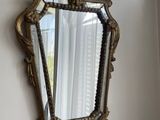 a mirror hanging on the wall next to a window