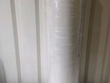 a roll of plastic wrap on top of a white table