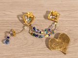two pieces of jewelry that are laying on a table