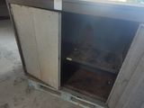 a metal cabinet with a door open in a garage