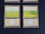 four cards with a picture of a landscape on them on a table