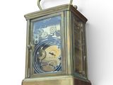 a clock that is attached to a wall on a white background