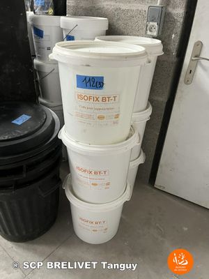 several buckets of food are stacked on top of each other in front of a refrigerator