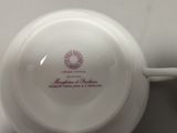 a white bowl with a red design on it