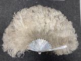 a picture of a white feathered hat with a parasol on top of it