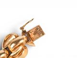 a close up of a gold chain with a usb drive attached