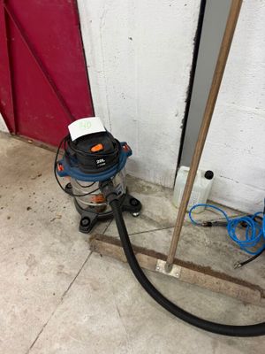 an image of a vacuum and a hose next to a red door