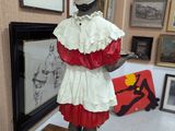 a statue of a woman in a red and white dress