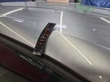 a remote control on the hood of a car