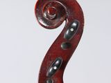 an antique violin with a scroll and a bow on a white background