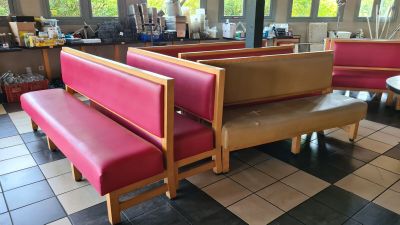 tables and benches in a restaurant with a checkered floor
