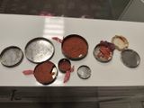 several pans of food are sitting on a white counter top