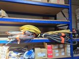 a bunch of wires on a shelf in a warehouse