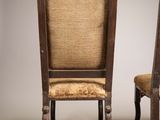 pair of antique wooden chairs with upholstered seats against a white background