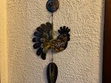 a metal bird hanging on a wall next to a door