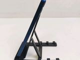 a cell phone on a stand on a white table