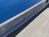 a picture of a blue car with a dent in the side