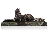 a statue of a cat laying down on a marble base