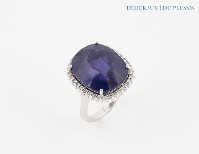 a close up of a ring with a blue stone on it