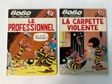 two books on a white surface with a cartoon character on the cover